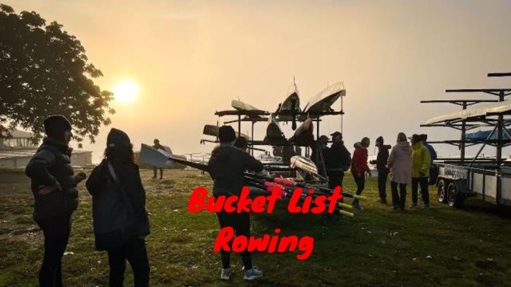 Rowing trailer of boats silhouette against low winter sun with people in foreground